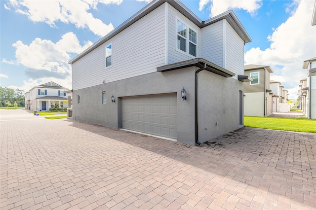 view of side of home featuring a garage