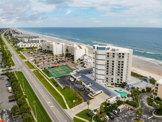 birds eye view of property with a water view and a beach view