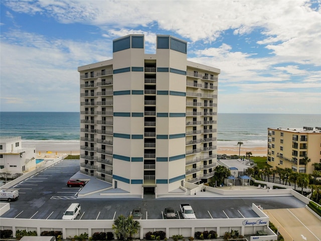 view of property with a beach view and a water view