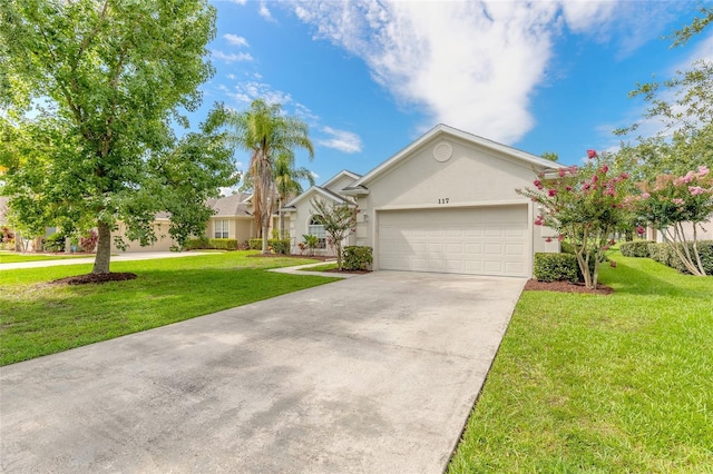 view of front of home with a front yard and a garage