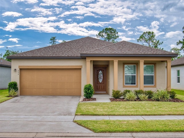 view of front facade with a garage and a front yard