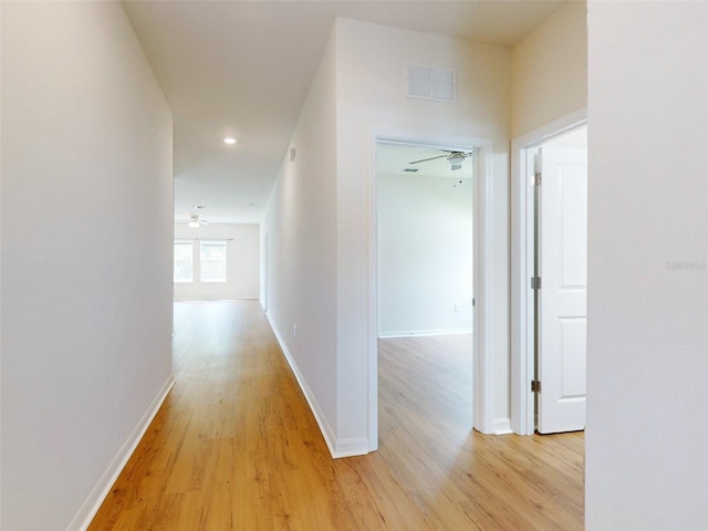 hallway with light hardwood / wood-style flooring