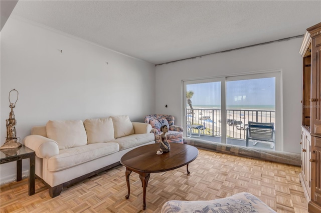 living room with light parquet flooring, a textured ceiling, and a water view