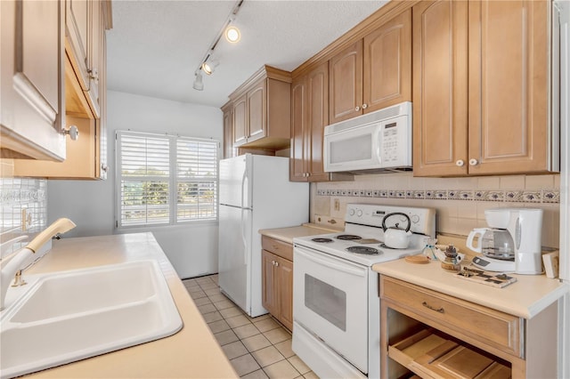 kitchen with sink, a textured ceiling, light tile patterned floors, white appliances, and decorative backsplash