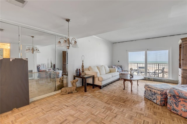 living room with light parquet flooring and a chandelier