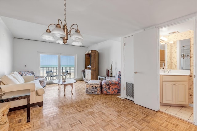 living room with a notable chandelier, sink, and light parquet floors