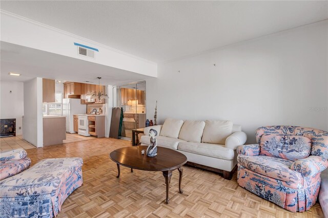 living room featuring ornamental molding and light parquet flooring