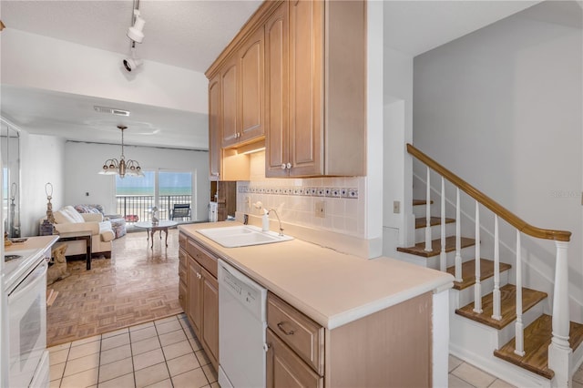 kitchen featuring sink, range, light brown cabinets, dishwasher, and a notable chandelier