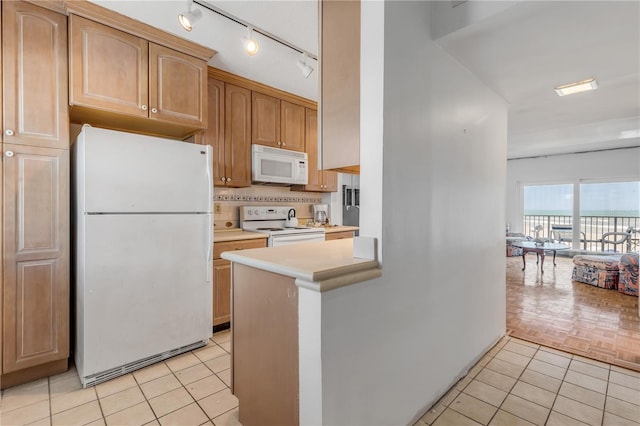 kitchen with tasteful backsplash, light tile patterned floors, and white appliances