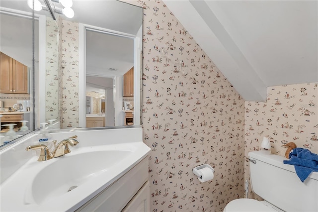 bathroom featuring vanity, beamed ceiling, and toilet