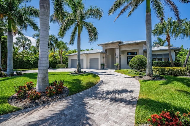 view of front of property with a garage and a front yard