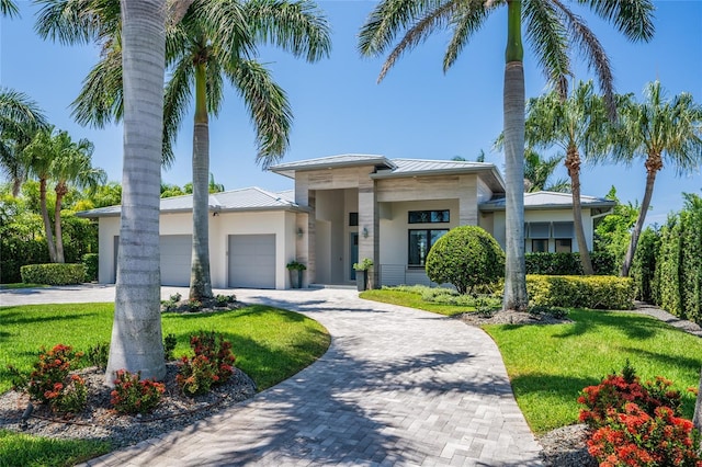 view of front of home with a garage and a front yard