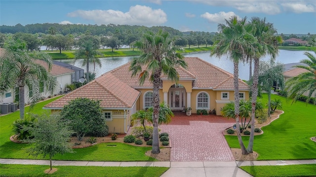 mediterranean / spanish-style home featuring a water view, a front yard, and central AC