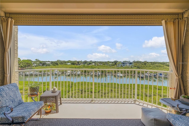 sunroom / solarium featuring a water view