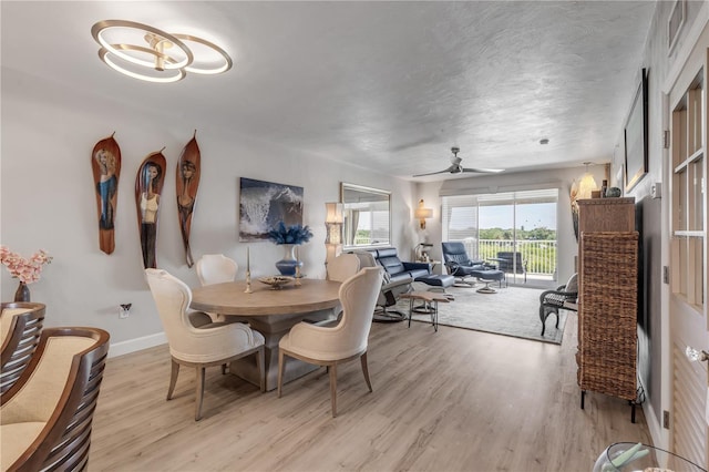 dining area with ceiling fan and light hardwood / wood-style flooring