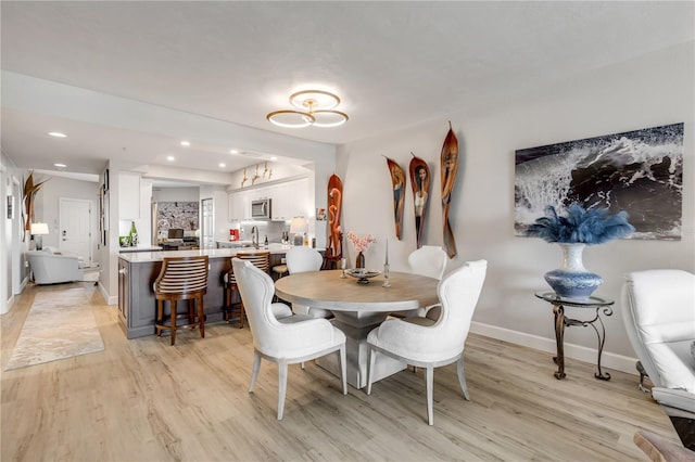 dining area featuring light hardwood / wood-style floors and sink