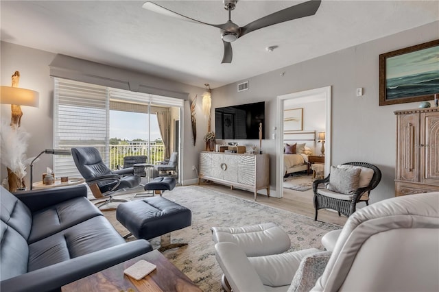 living room with hardwood / wood-style flooring and ceiling fan