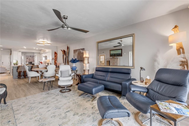 living room featuring light wood-type flooring and ceiling fan