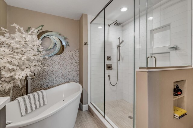 bathroom with separate shower and tub