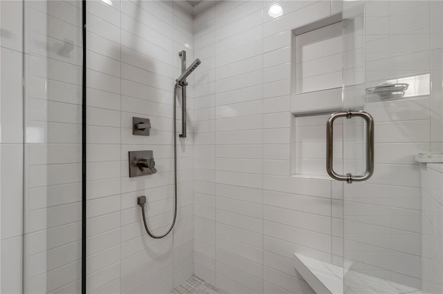 bathroom featuring a shower with shower door