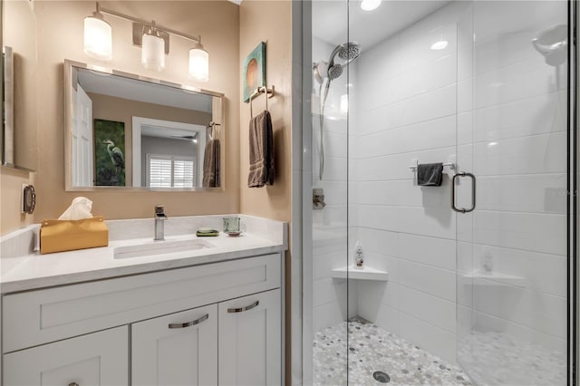 bathroom featuring vanity and a shower with shower door