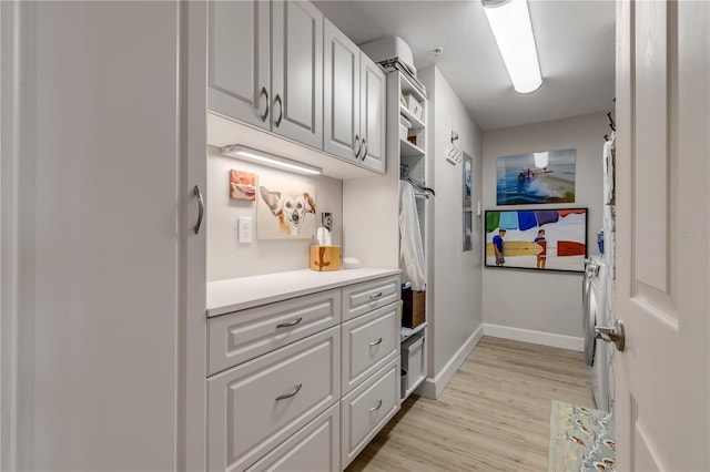 interior space featuring light wood-type flooring and white cabinetry