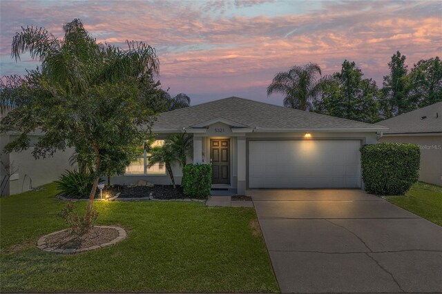 view of front of home featuring a yard and a garage