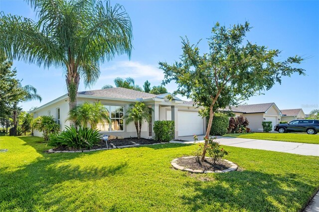 ranch-style house featuring a front lawn and a garage