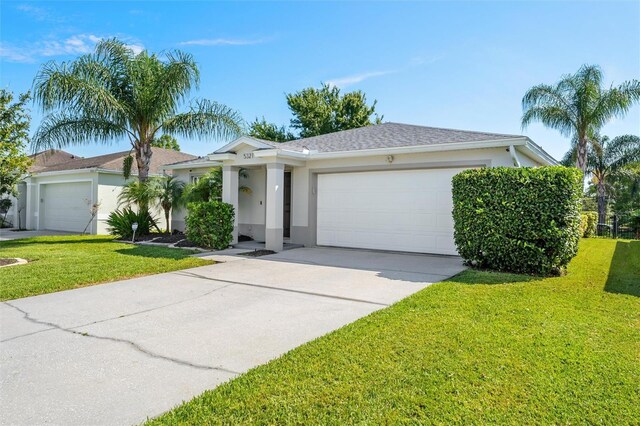 view of front of property with a garage and a front lawn