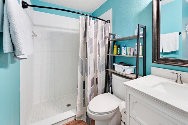 bathroom with vanity, toilet, and walk in shower