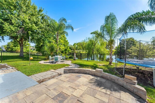 view of patio featuring a water view and a trampoline