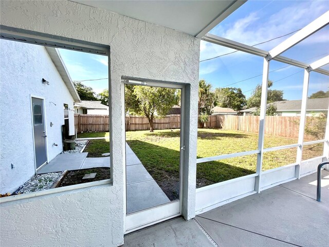 doorway to outside featuring a healthy amount of sunlight and concrete flooring