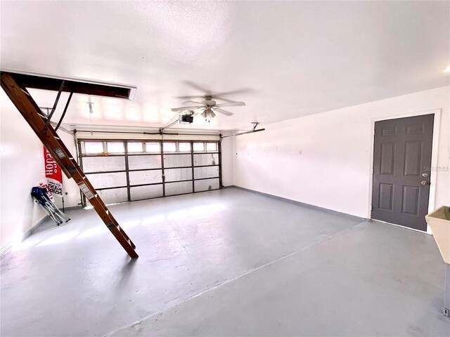 garage featuring a garage door opener and ceiling fan