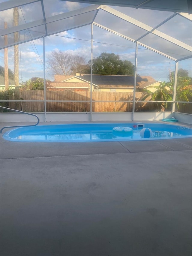 view of swimming pool with a lanai