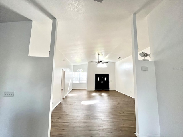 foyer entrance with vaulted ceiling, dark hardwood / wood-style floors, and ceiling fan