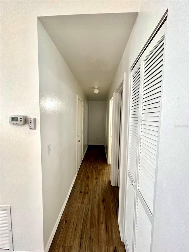 corridor featuring dark hardwood / wood-style flooring