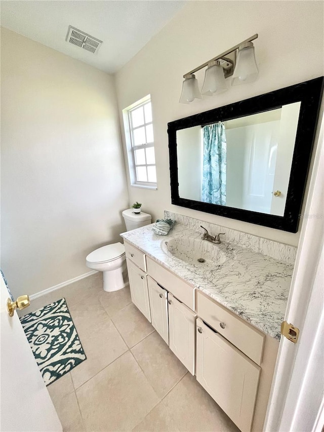 bathroom with tile patterned floors, vanity, and toilet