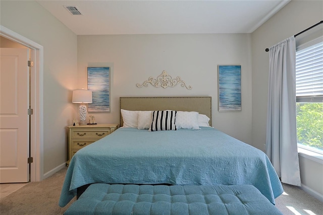 bedroom featuring light carpet