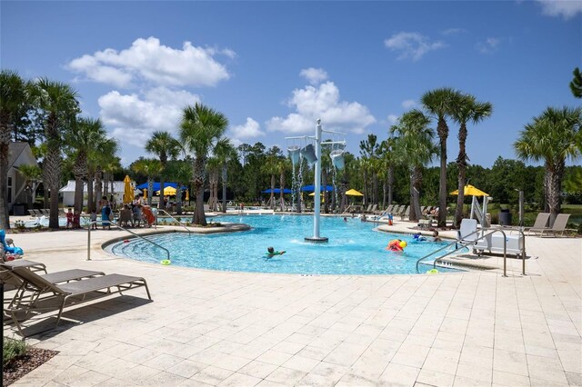 view of pool with a patio area and pool water feature