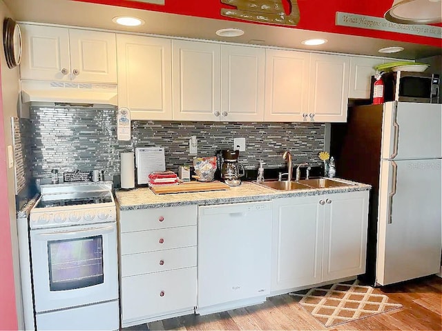 kitchen with white cabinetry, wall chimney range hood, and white appliances