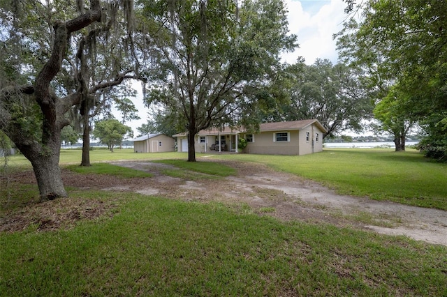 ranch-style home with driveway and a front yard