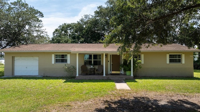 ranch-style home with a front yard, covered porch, brick siding, and an attached garage