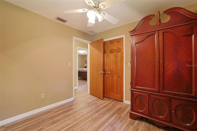 unfurnished bedroom with light wood-type flooring, visible vents, ceiling fan, and baseboards