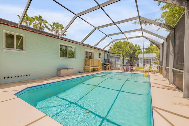 view of pool with a lanai and a patio