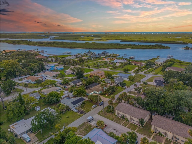 aerial view at dusk with a water view