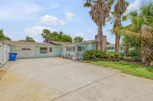 ranch-style home with a front yard and a garage