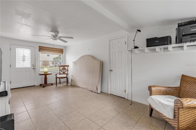 entrance foyer with ceiling fan and beamed ceiling