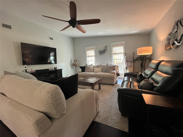 living room with hardwood / wood-style flooring, ceiling fan, and vaulted ceiling