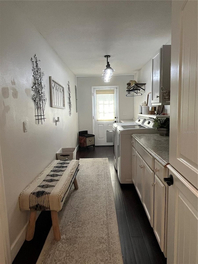 clothes washing area with cabinet space, independent washer and dryer, and dark wood-style floors