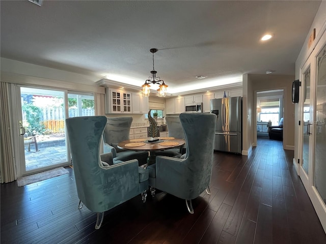 dining room featuring dark hardwood / wood-style flooring and an inviting chandelier